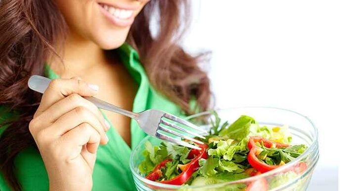 girl eating vegetable salad on protein diet